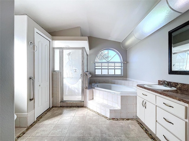 bathroom with tile patterned floors, vanity, plus walk in shower, and vaulted ceiling