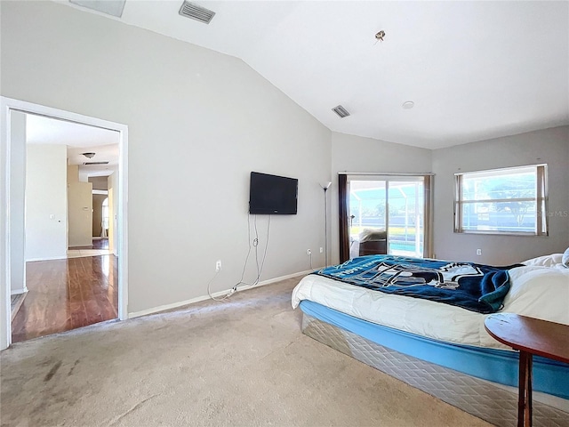 carpeted bedroom featuring vaulted ceiling