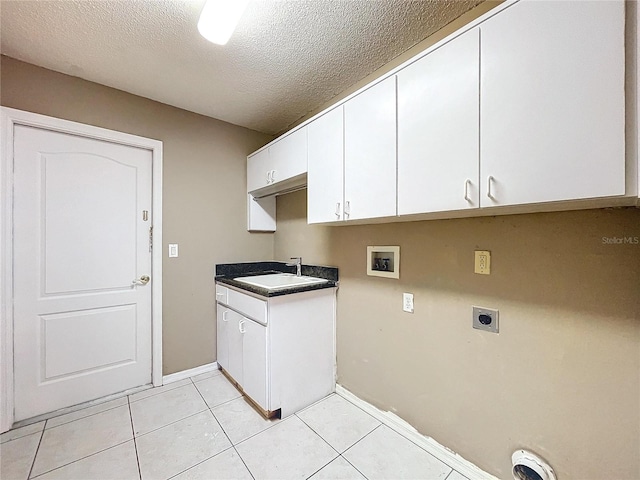 laundry room featuring sink, cabinets, electric dryer hookup, hookup for a washing machine, and a textured ceiling