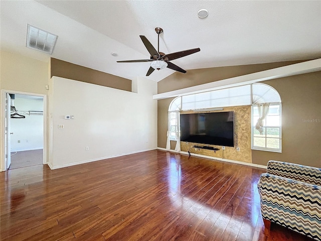 unfurnished living room with dark hardwood / wood-style floors, vaulted ceiling, and ceiling fan