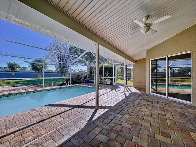 view of swimming pool with a patio, ceiling fan, and a lanai