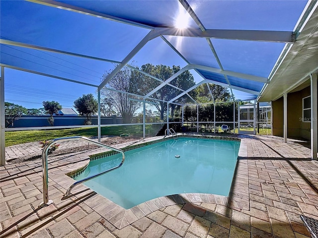 view of pool with glass enclosure and a patio