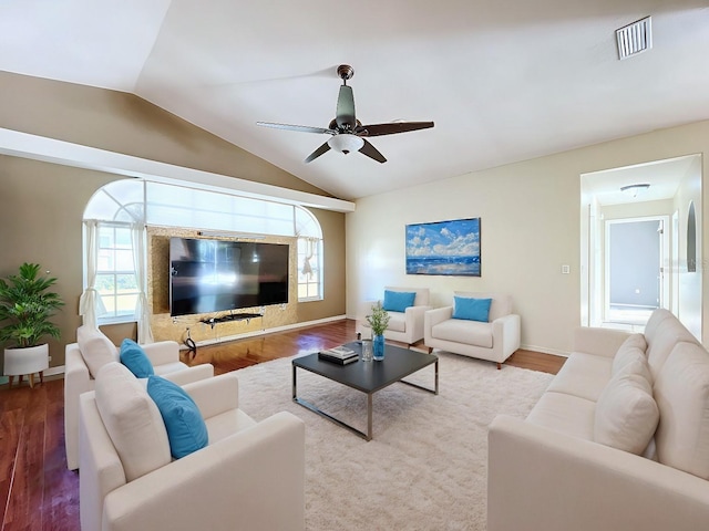 living room featuring vaulted ceiling, light hardwood / wood-style flooring, and ceiling fan