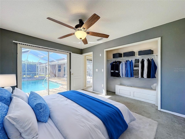 bedroom featuring access to outside, a textured ceiling, a closet, and ceiling fan