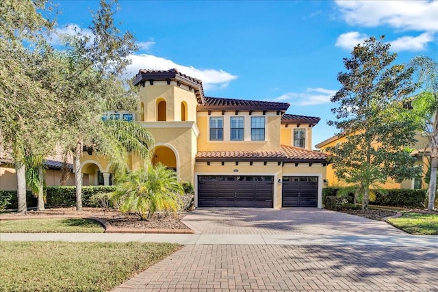 mediterranean / spanish house with a garage