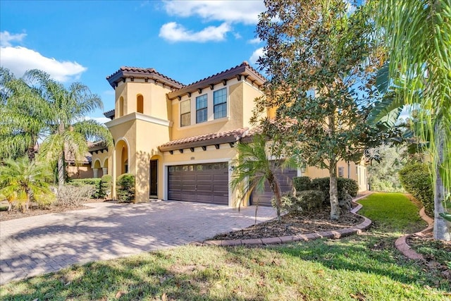 mediterranean / spanish-style home with a garage