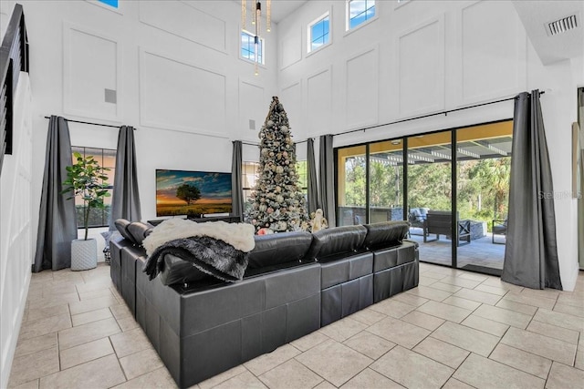 living room featuring a wealth of natural light and a towering ceiling