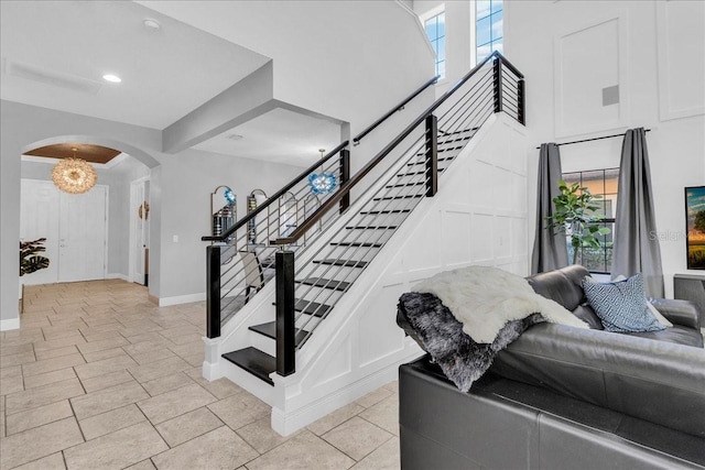 stairs with an inviting chandelier