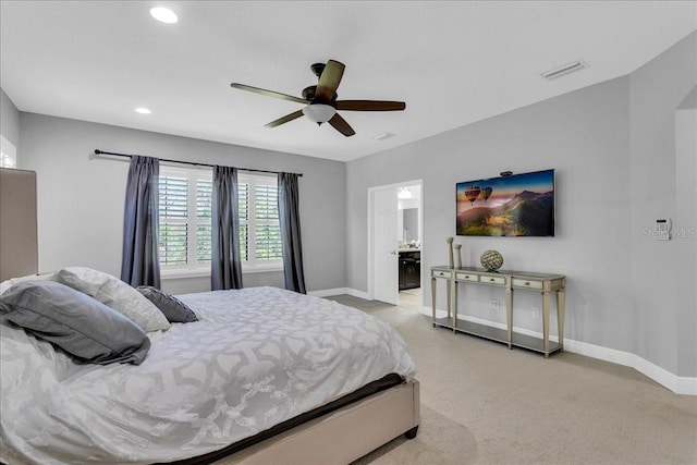 carpeted bedroom featuring ceiling fan and connected bathroom