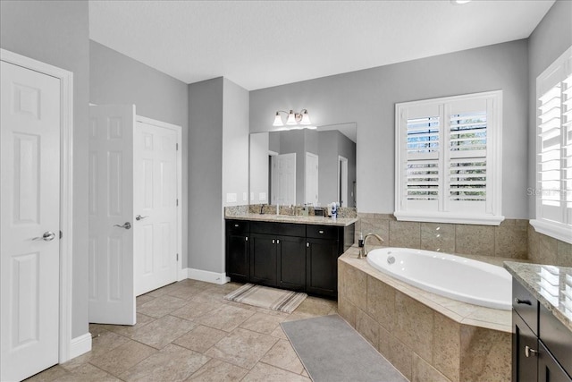 bathroom featuring vanity and tiled bath