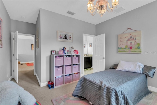 bedroom with light colored carpet, a notable chandelier, and ensuite bathroom