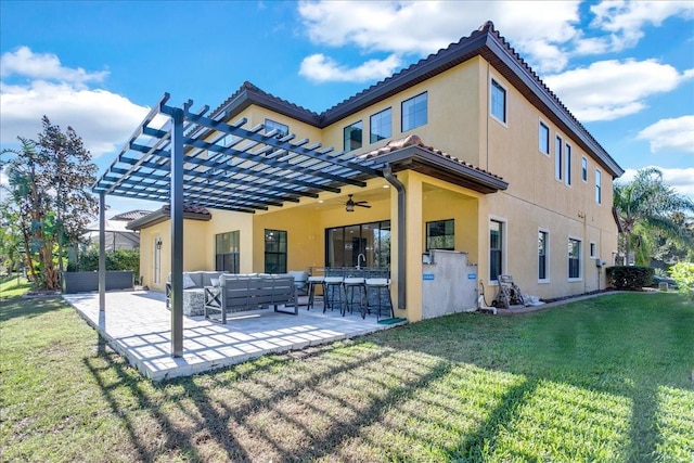 back of house with a lawn, an outdoor living space, a patio area, and a bar