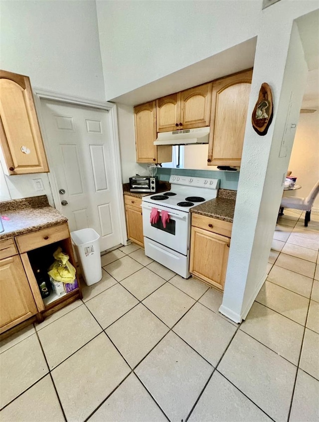 kitchen with white range with electric stovetop, light tile patterned floors, and light brown cabinetry