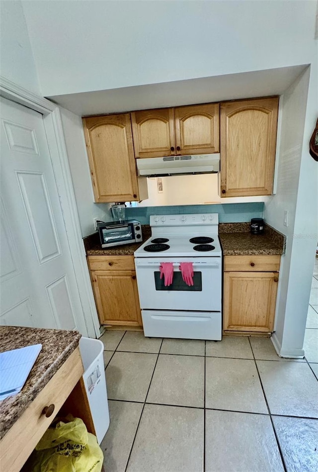 kitchen with white electric range, light brown cabinets, and light tile patterned floors