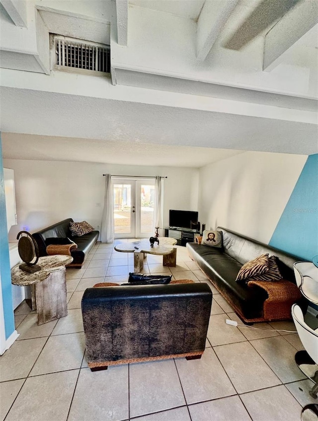 tiled living room with a textured ceiling and french doors