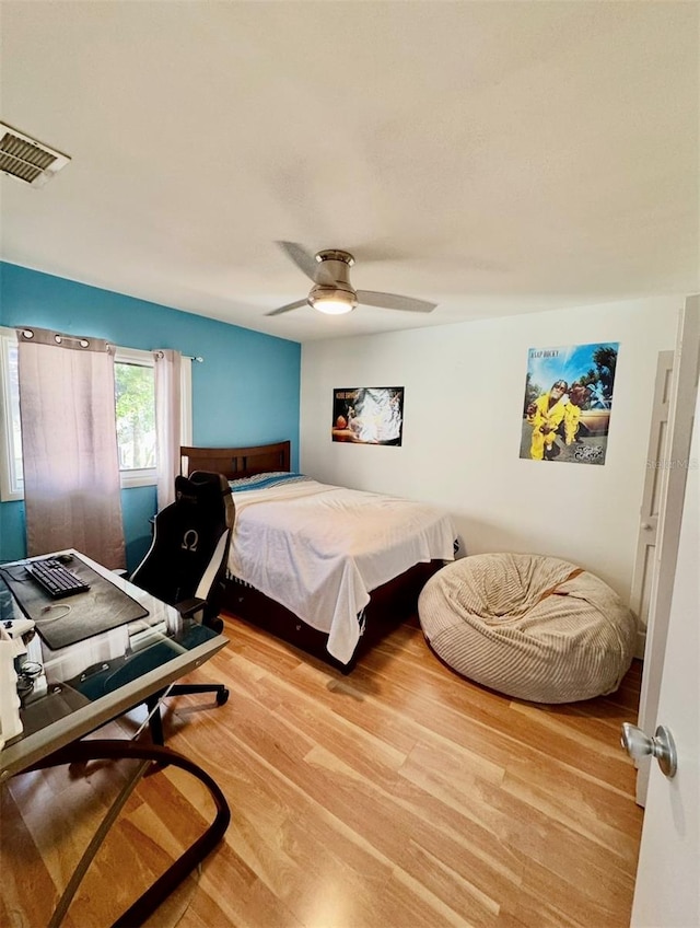 bedroom with hardwood / wood-style floors and ceiling fan