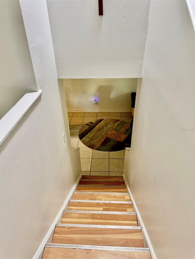 stairway with hardwood / wood-style flooring