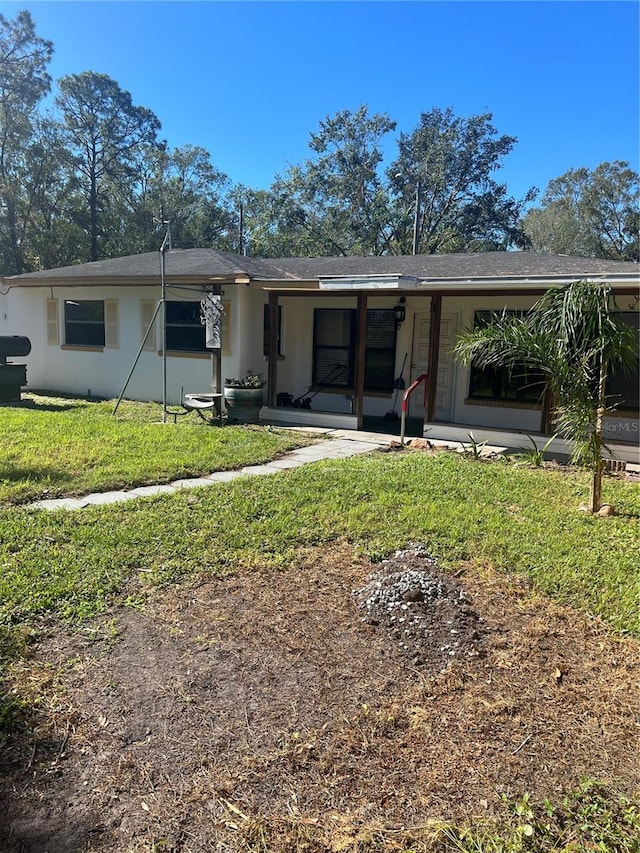 rear view of house featuring a yard