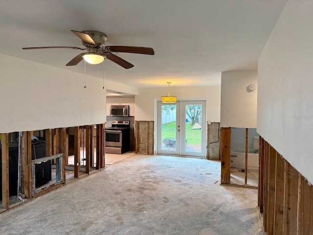 unfurnished living room featuring french doors and ceiling fan