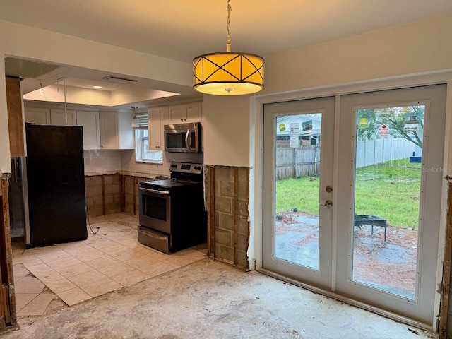 kitchen featuring french doors, tasteful backsplash, stainless steel appliances, pendant lighting, and white cabinets