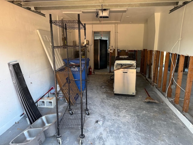 garage featuring stainless steel refrigerator and a garage door opener