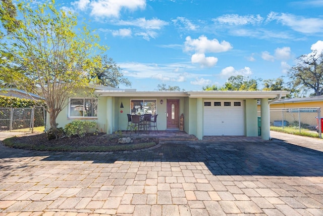 ranch-style house featuring a porch and a garage