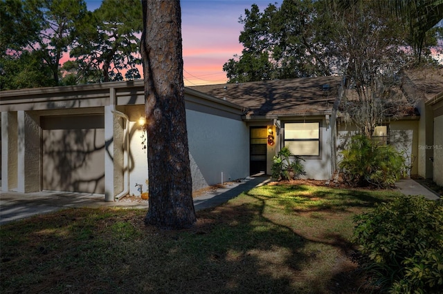 view of front of home featuring a garage and a lawn