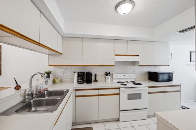 kitchen featuring electric stove, sink, and white cabinetry