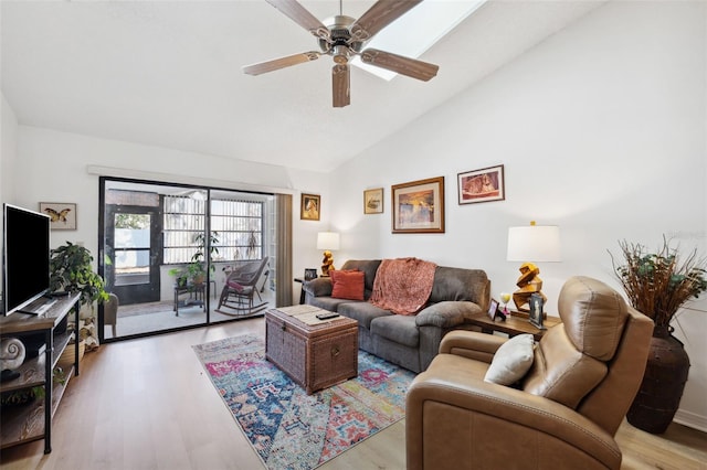 living room with ceiling fan, lofted ceiling, and light hardwood / wood-style flooring