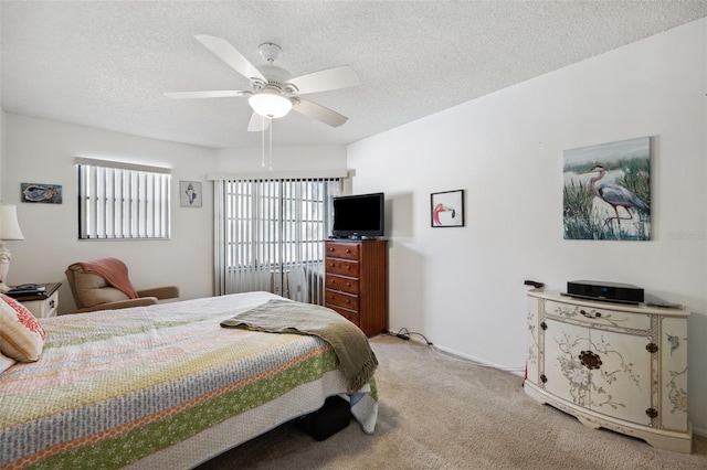 carpeted bedroom with a textured ceiling and ceiling fan