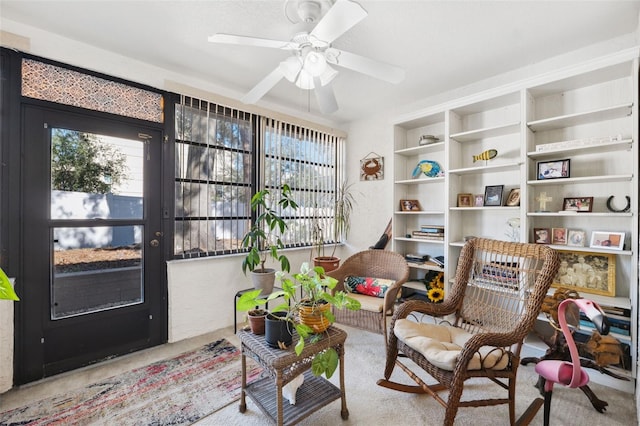 sitting room featuring ceiling fan and light colored carpet