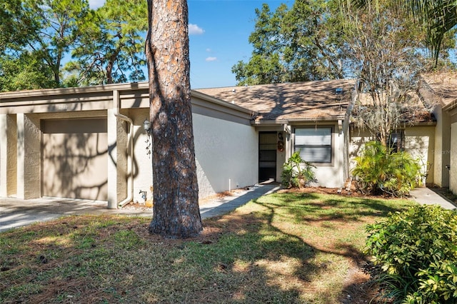 exterior space with a garage and a lawn