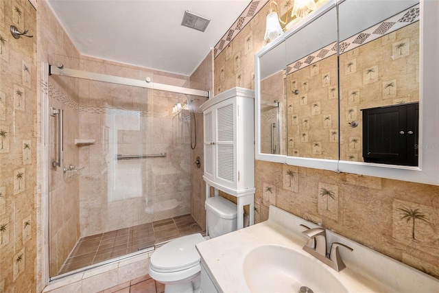 bathroom with vanity, tile patterned flooring, toilet, tile walls, and an enclosed shower