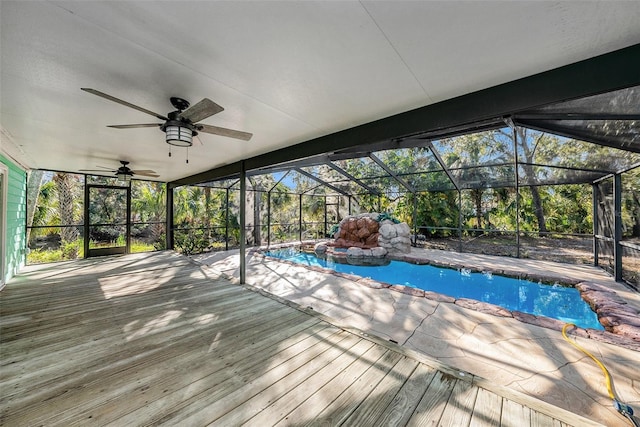 view of pool with a lanai and ceiling fan