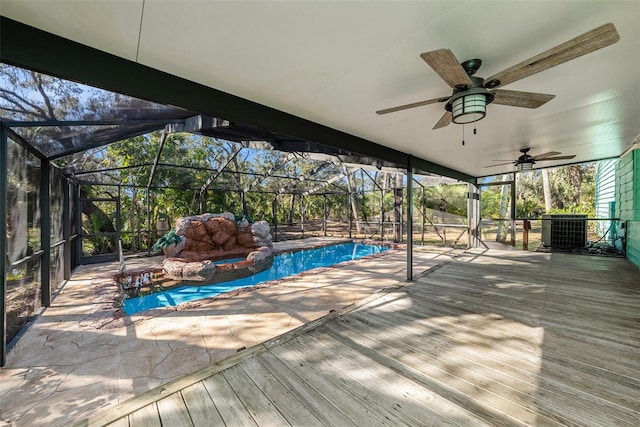 view of swimming pool featuring glass enclosure, ceiling fan, and central air condition unit