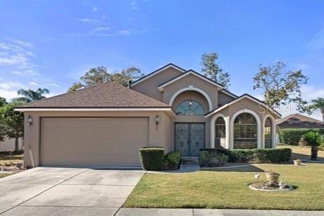 view of front facade with a garage and a front yard