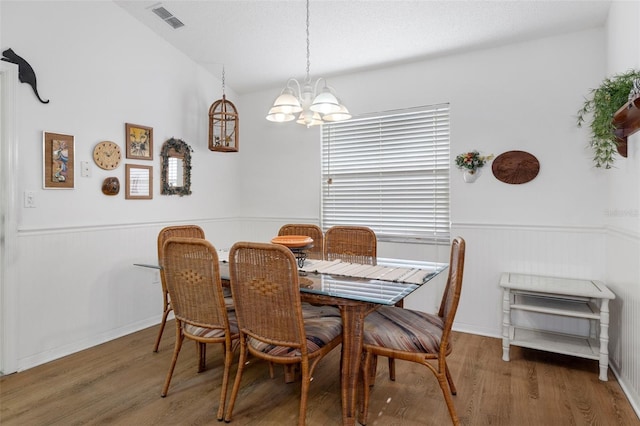 dining room with a notable chandelier and hardwood / wood-style flooring