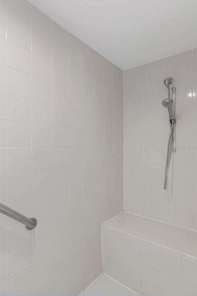 bathroom with tiled shower