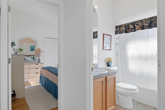 full bathroom featuring hardwood / wood-style flooring, vanity, shower / bath combo, and toilet