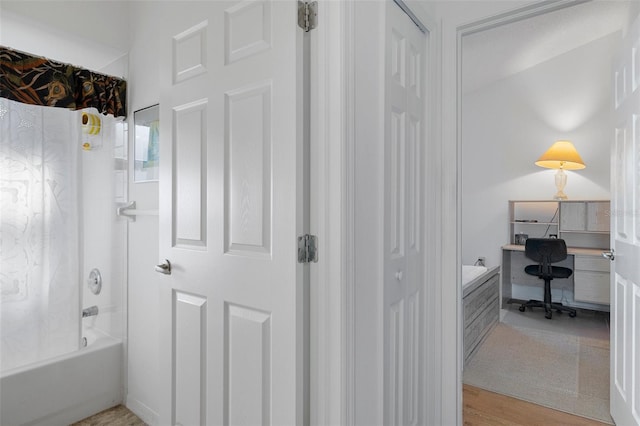 bathroom featuring wood-type flooring and shower / tub combination