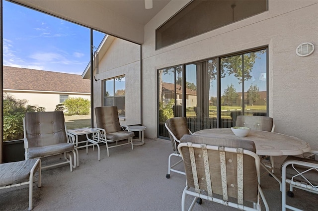 sunroom with vaulted ceiling with beams and a healthy amount of sunlight