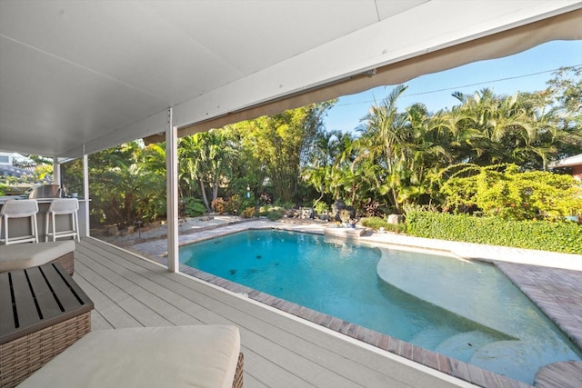 view of swimming pool with a wooden deck