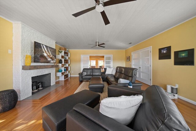 living room with a fireplace, hardwood / wood-style floors, french doors, and ceiling fan