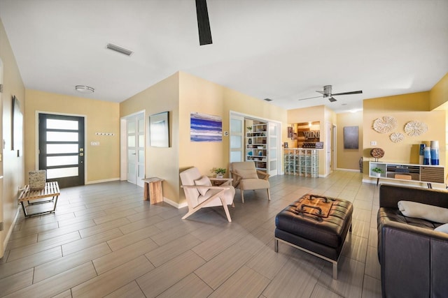 living room featuring ceiling fan and hardwood / wood-style flooring