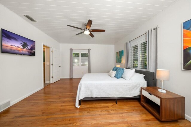 bedroom with wood-type flooring and ceiling fan