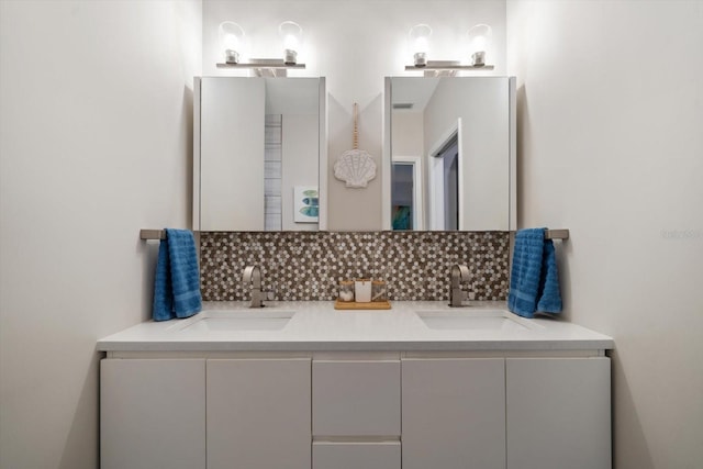 bathroom with decorative backsplash and vanity