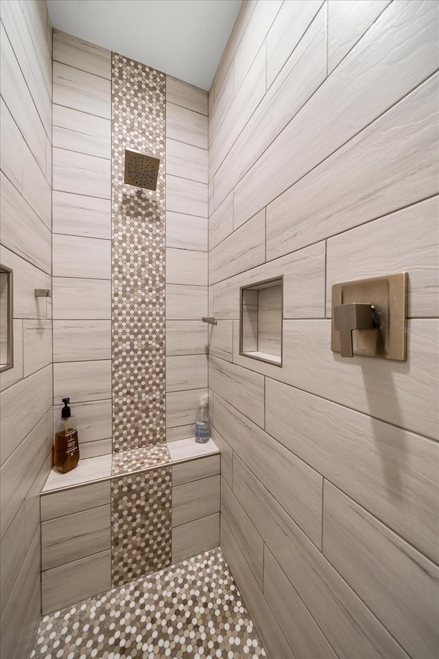 bathroom with tiled shower