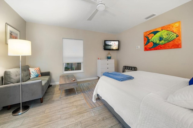 bedroom with ceiling fan and light hardwood / wood-style flooring