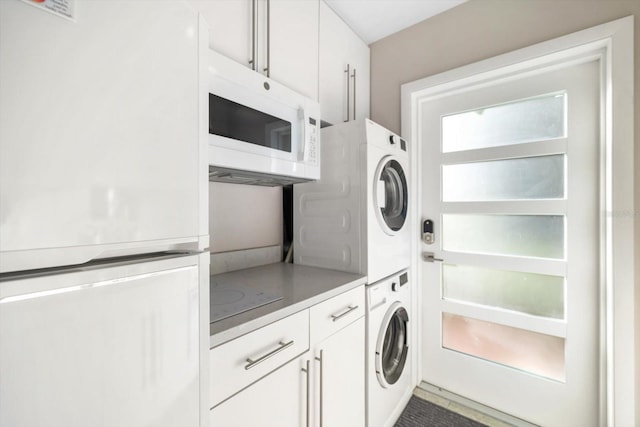 laundry area featuring stacked washer and clothes dryer