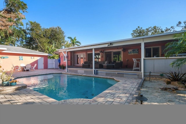 view of swimming pool with a patio and french doors